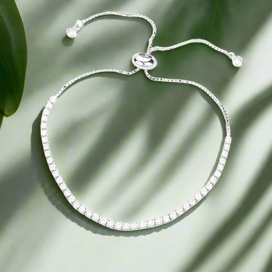 Silver bracelet with clear stones on a light gray background
